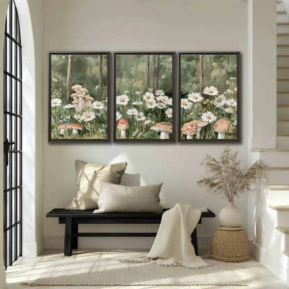 Pale pink mushrooms nestled among white daisies and tall green woodland grasses 3 piece framed canvas wall art displayed in a entryway