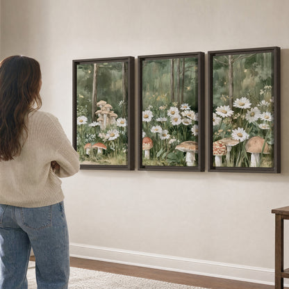 Pale pink mushrooms nestled among white daisies and tall green woodland grasses 3 piece framed canvas wall art three panel arrangement on a wall