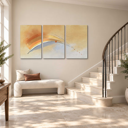 A sweeping ochre and orange arc with fine blue accents on a warm cream background 3 piece canvas wall art styled in an interior