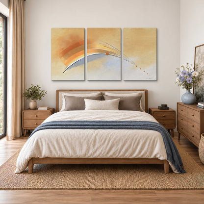 A sweeping ochre and orange arc with fine blue accents on a warm cream background 3 piece canvas wall art styled in an interior