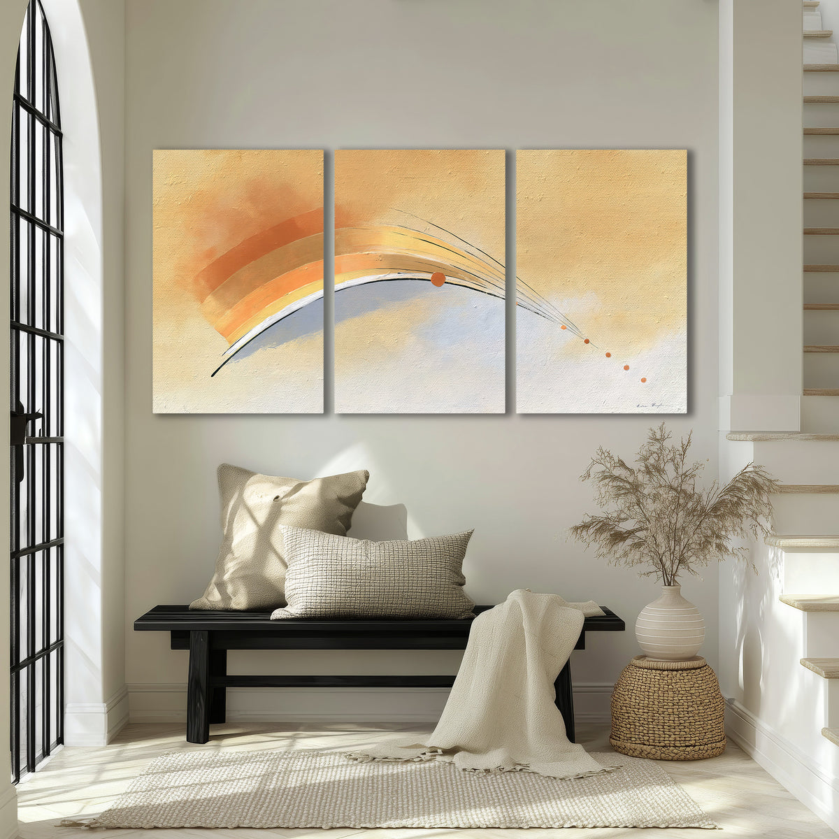 A sweeping ochre and orange arc with fine blue accents on a warm cream background 3 piece canvas wall art displayed in a entryway