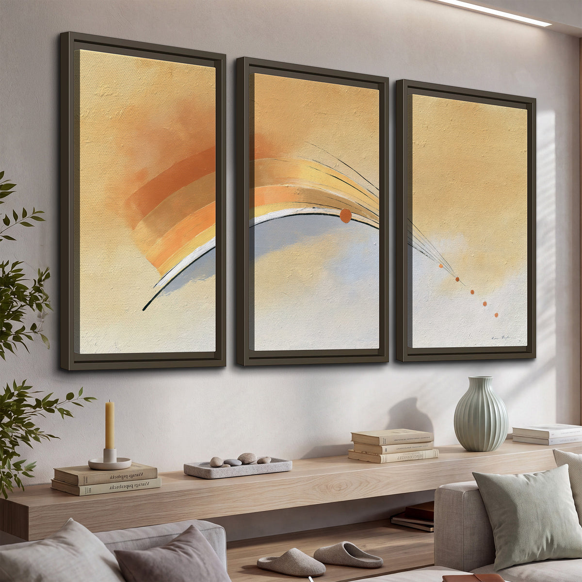 A sweeping ochre and orange arc with fine blue accents on a warm cream background 3 piece framed canvas wall art displayed in a console