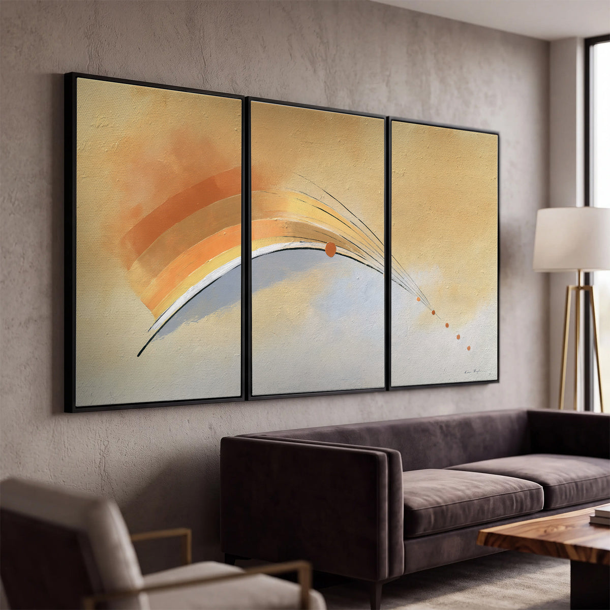 A sweeping ochre and orange arc with fine blue accents on a warm cream background 3 piece framed canvas wall art displayed in a modern living room