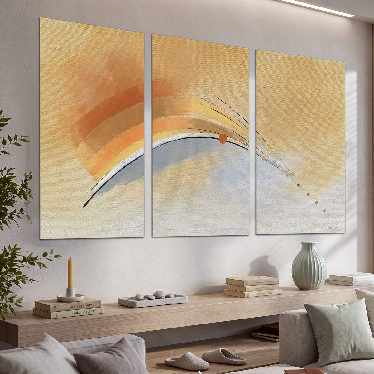 A sweeping ochre and orange arc with fine blue accents on a warm cream background set of 3 poster prints displayed in a console