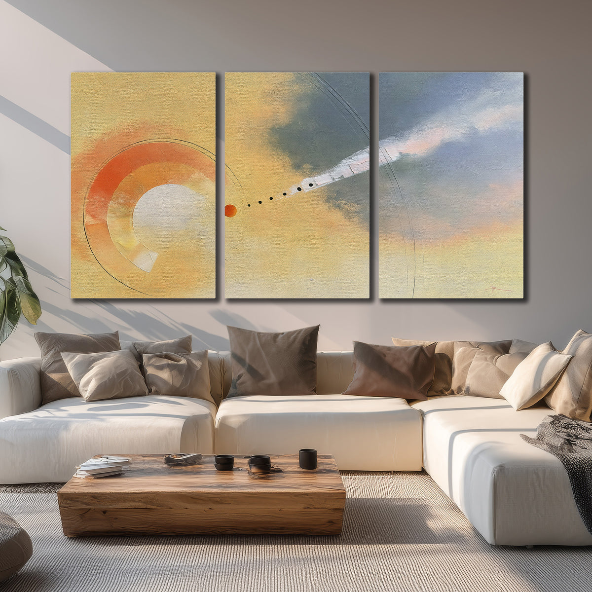 A warm orange circular form and diagonal pale streaks across a muted yellow and blue field 3 piece canvas wall art displayed in a living room