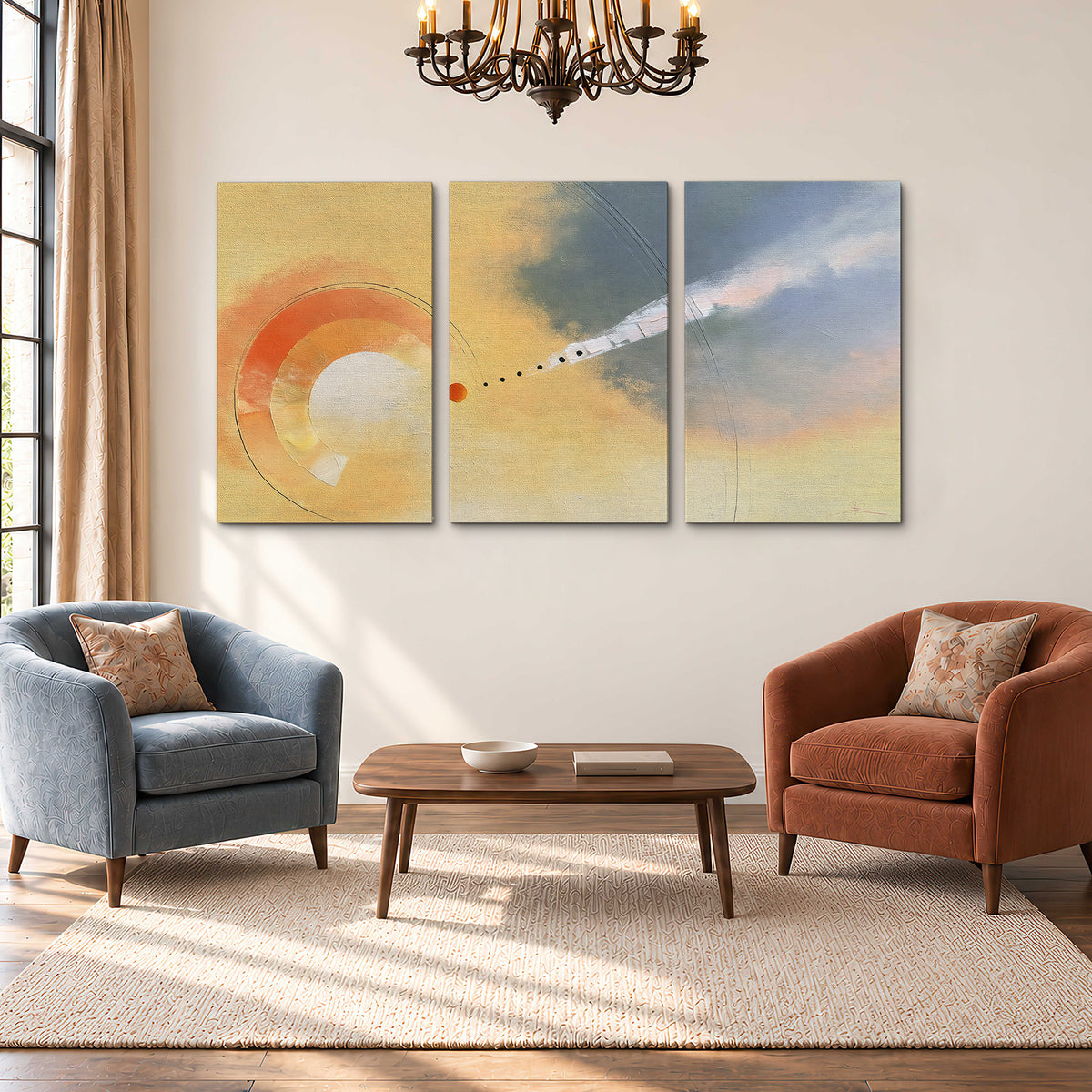 A warm orange circular form and diagonal pale streaks across a muted yellow and blue field 3 piece canvas wall art styled in an interior