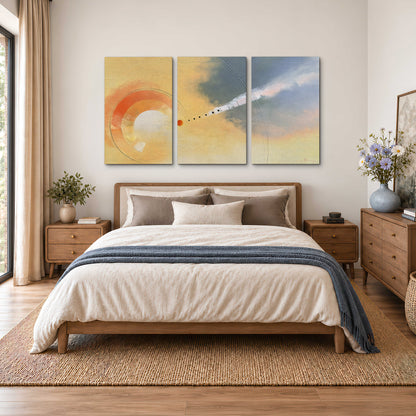 A warm orange circular form and diagonal pale streaks across a muted yellow and blue field 3 piece canvas wall art styled in an interior