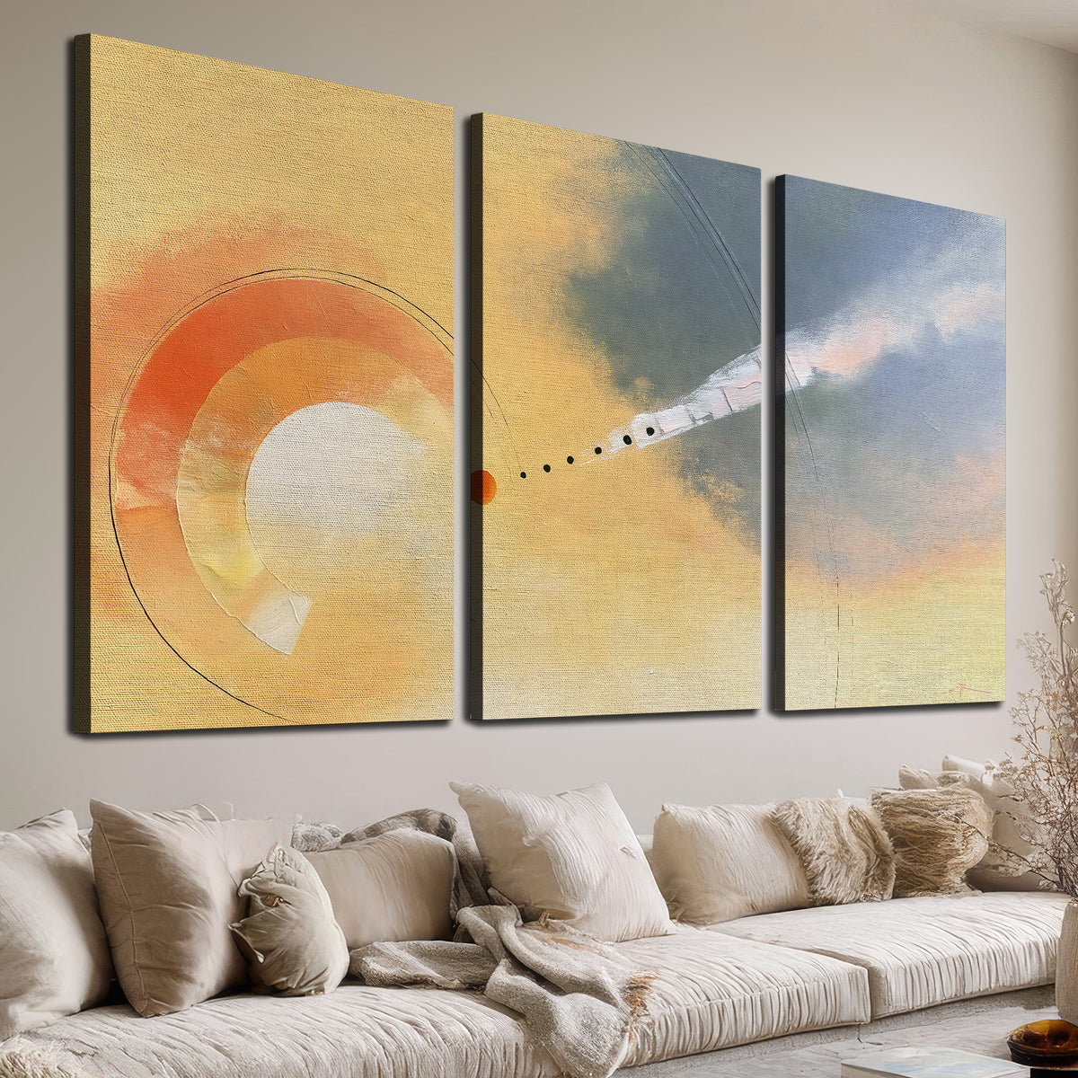 A warm orange circular form and diagonal pale streaks across a muted yellow and blue field 3 piece canvas wall art room and product view