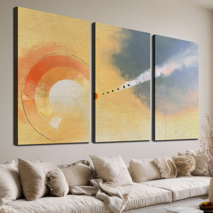A warm orange circular form and diagonal pale streaks across a muted yellow and blue field 3 piece canvas wall art room and product view
