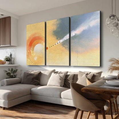 A warm orange circular form and diagonal pale streaks across a muted yellow and blue field 3 piece canvas wall art room and product view