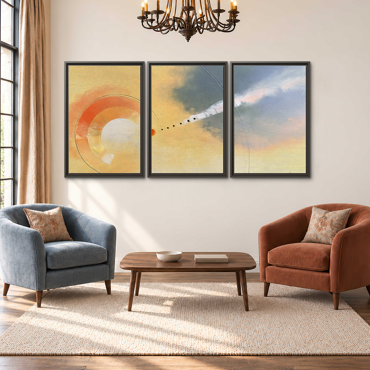 A warm orange circular form and diagonal pale streaks across a muted yellow and blue field 3 piece framed canvas wall art styled in an interior