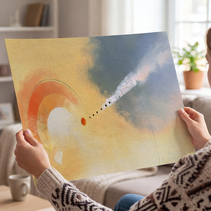 A warm orange circular form and diagonal pale streaks across a muted yellow and blue field single poster print held in hands