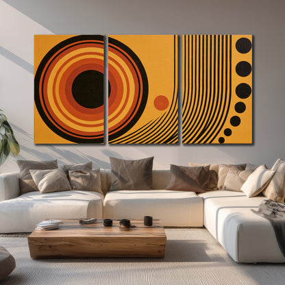 Bold black, orange and golden circles with parallel curved lines and small dots 3 piece canvas wall art displayed in a living room