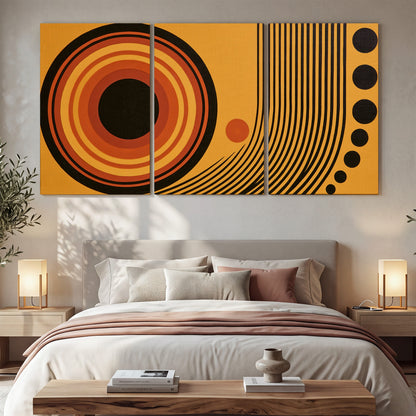 Bold black, orange and golden circles with parallel curved lines and small dots 3 piece canvas wall art displayed in a bedroom