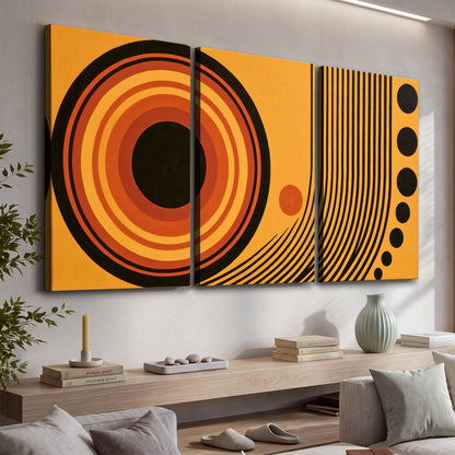 Bold black, orange and golden circles with parallel curved lines and small dots 3 piece canvas wall art displayed in a console