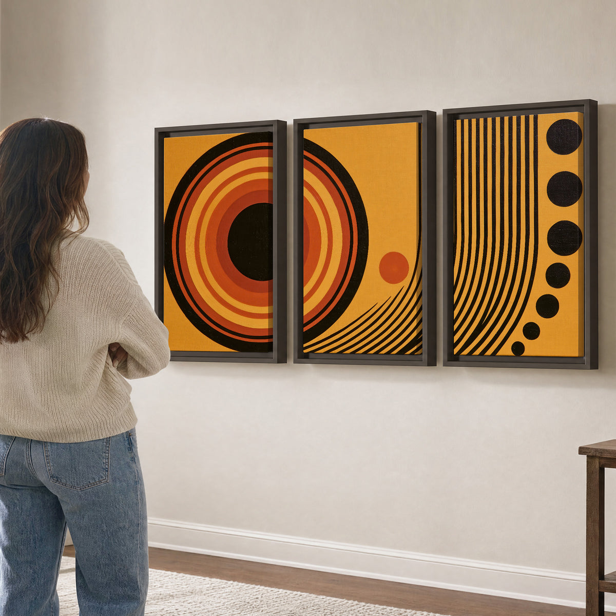 Bold black, orange and golden circles with parallel curved lines and small dots 3 piece framed canvas wall art three panel arrangement on a wall