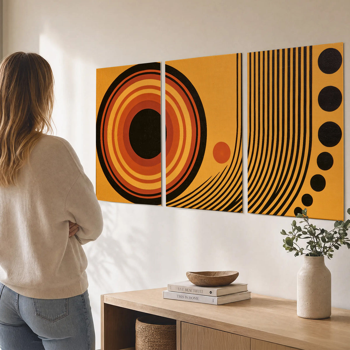 Bold black, orange and golden circles with parallel curved lines and small dots set of 3 poster prints three panel arrangement on a wall