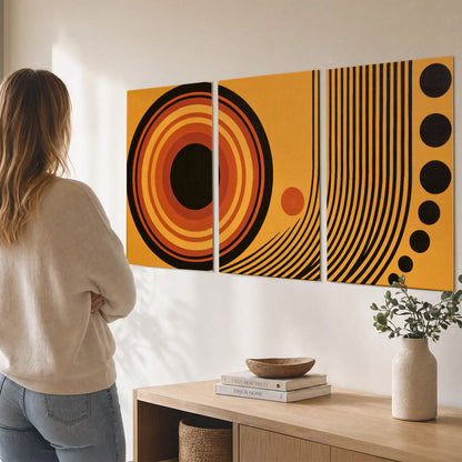 Bold black, orange and golden circles with parallel curved lines and small dots set of 3 poster prints three panel arrangement on a wall