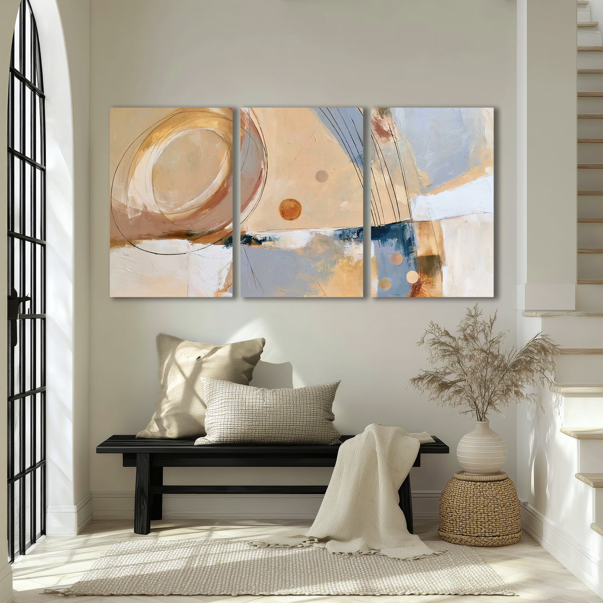 Pale circular forms and fine diagonal lines layered over blue, peach and cream brushstrokes 3 piece canvas wall art displayed in a entryway