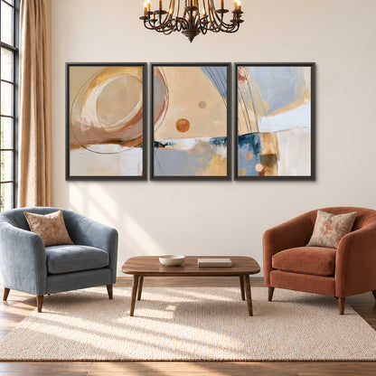 Pale circular forms and fine diagonal lines layered over blue, peach and cream brushstrokes 3 piece framed canvas wall art styled in an interior