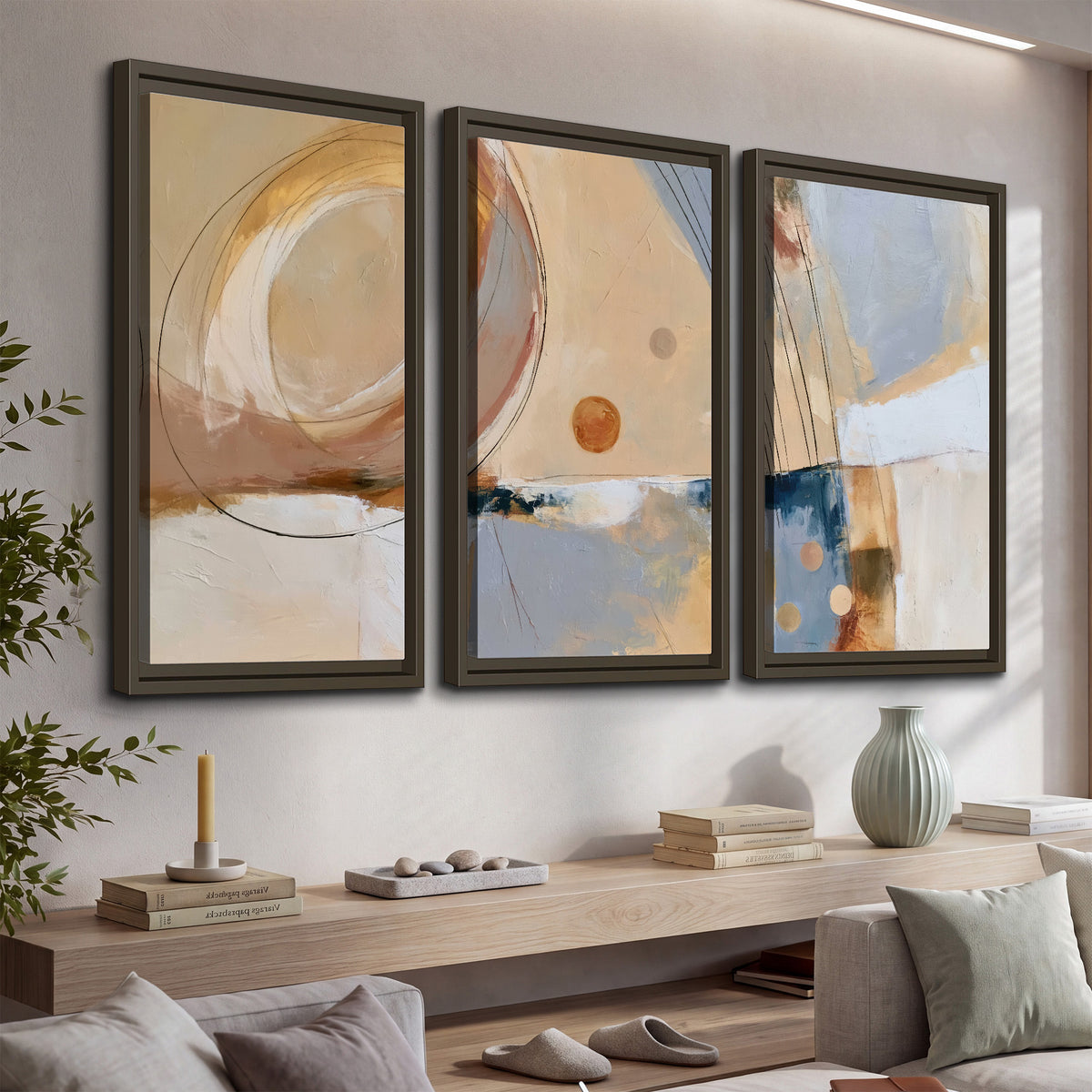 Pale circular forms and fine diagonal lines layered over blue, peach and cream brushstrokes 3 piece framed canvas wall art displayed in a console