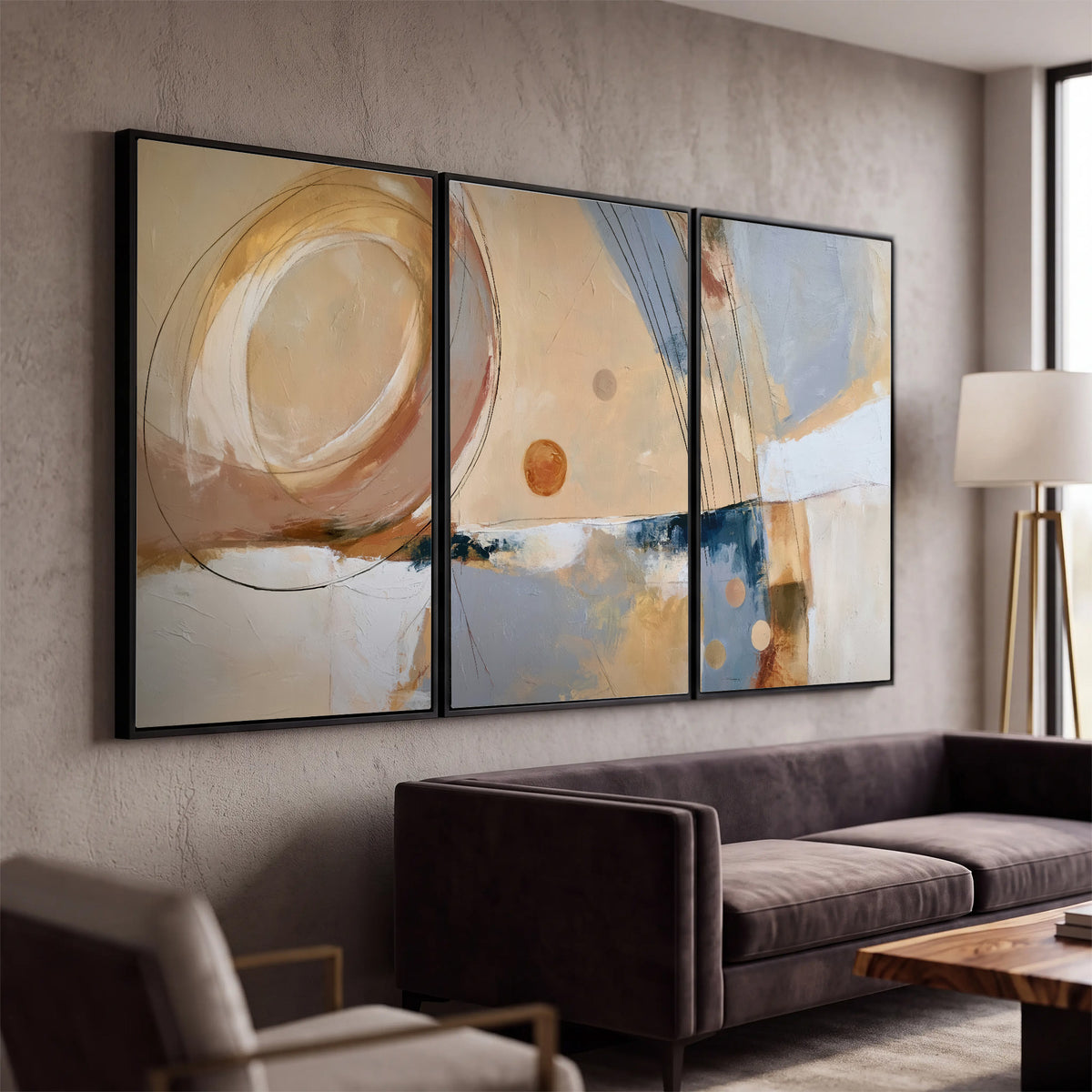 Pale circular forms and fine diagonal lines layered over blue, peach and cream brushstrokes 3 piece framed canvas wall art displayed in a modern living room
