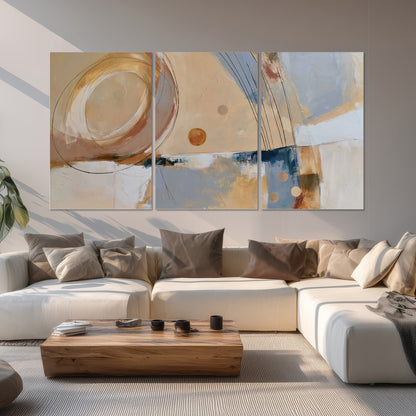 Pale circular forms and fine diagonal lines layered over blue, peach and cream brushstrokes set of 3 poster prints displayed in a living room
