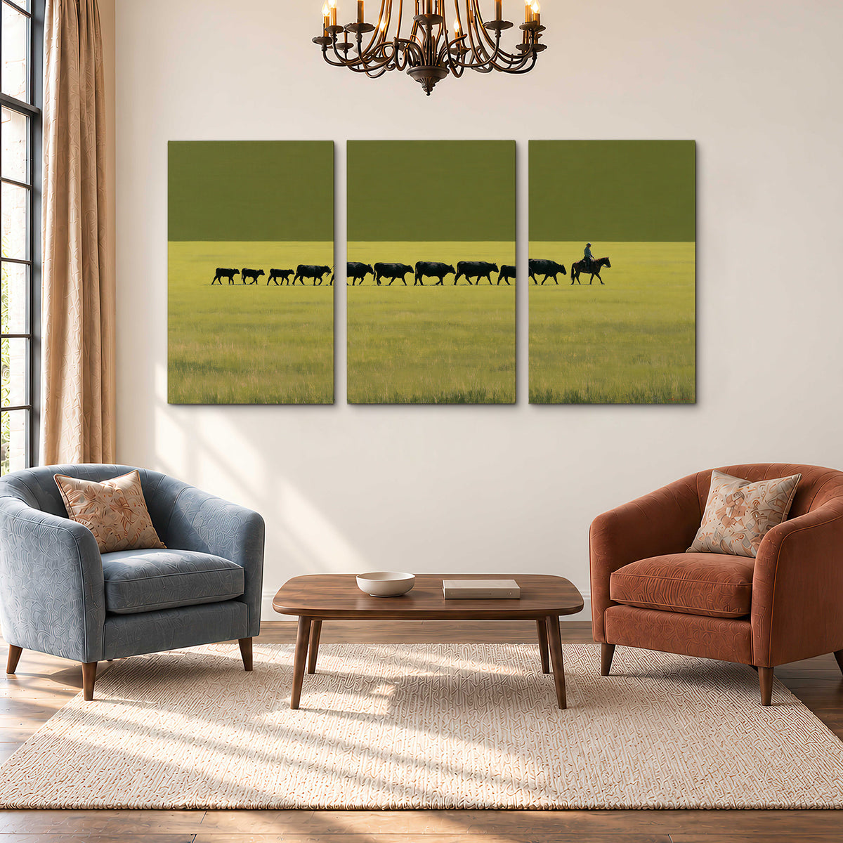 A rider leading a long line of cattle across a wide green and golden plain 3 piece canvas wall art styled in an interior