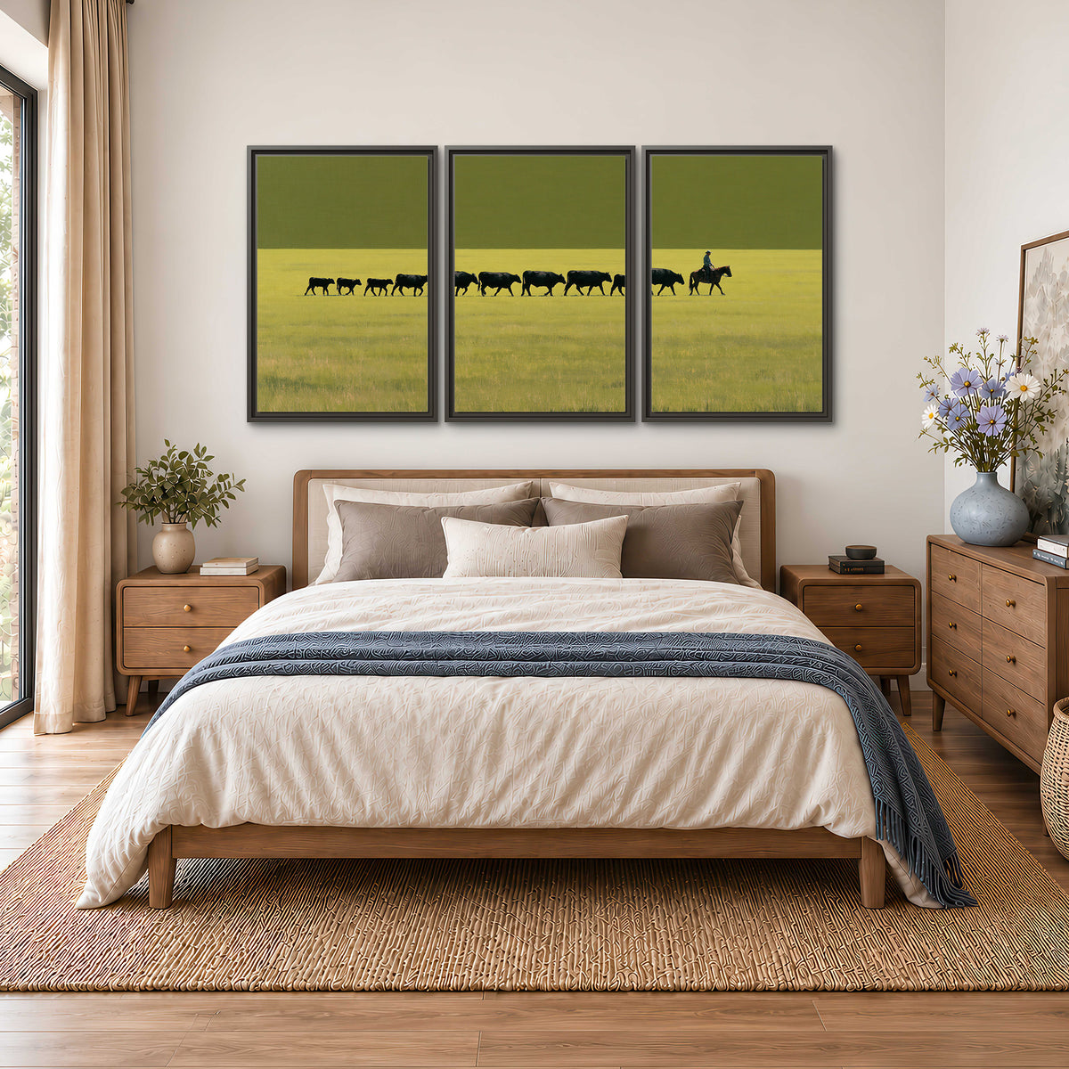 A rider leading a long line of cattle across a wide green and golden plain 3 piece framed canvas wall art styled in an interior