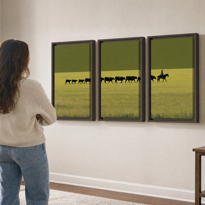 A rider leading a long line of cattle across a wide green and golden plain 3 piece framed canvas wall art three panel arrangement on a wall