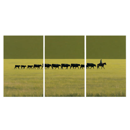 A rider leading a long line of cattle across a wide green and golden plain set of 3 poster prints viewed straight on