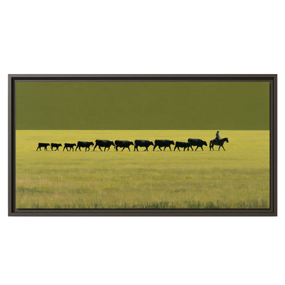 A rider leading a long line of cattle across a wide green and golden plain single framed canvas wall art viewed straight on