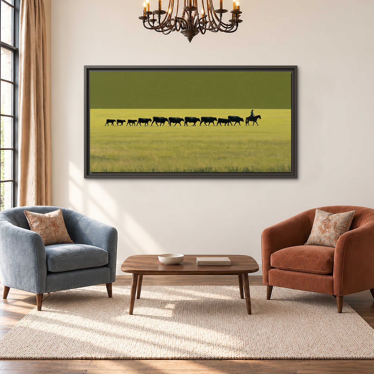 A rider leading a long line of cattle across a wide green and golden plain single framed canvas wall art styled in an interior