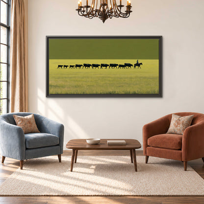 A rider leading a long line of cattle across a wide green and golden plain single framed canvas wall art styled in an interior