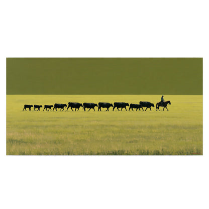 A rider leading a long line of cattle across a wide green and golden plain single poster print viewed straight on