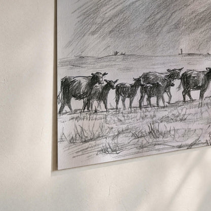 A rider on horseback guiding a herd of cattle across an open plain in charcoal-style strokes set of 3 poster prints material and edge close up