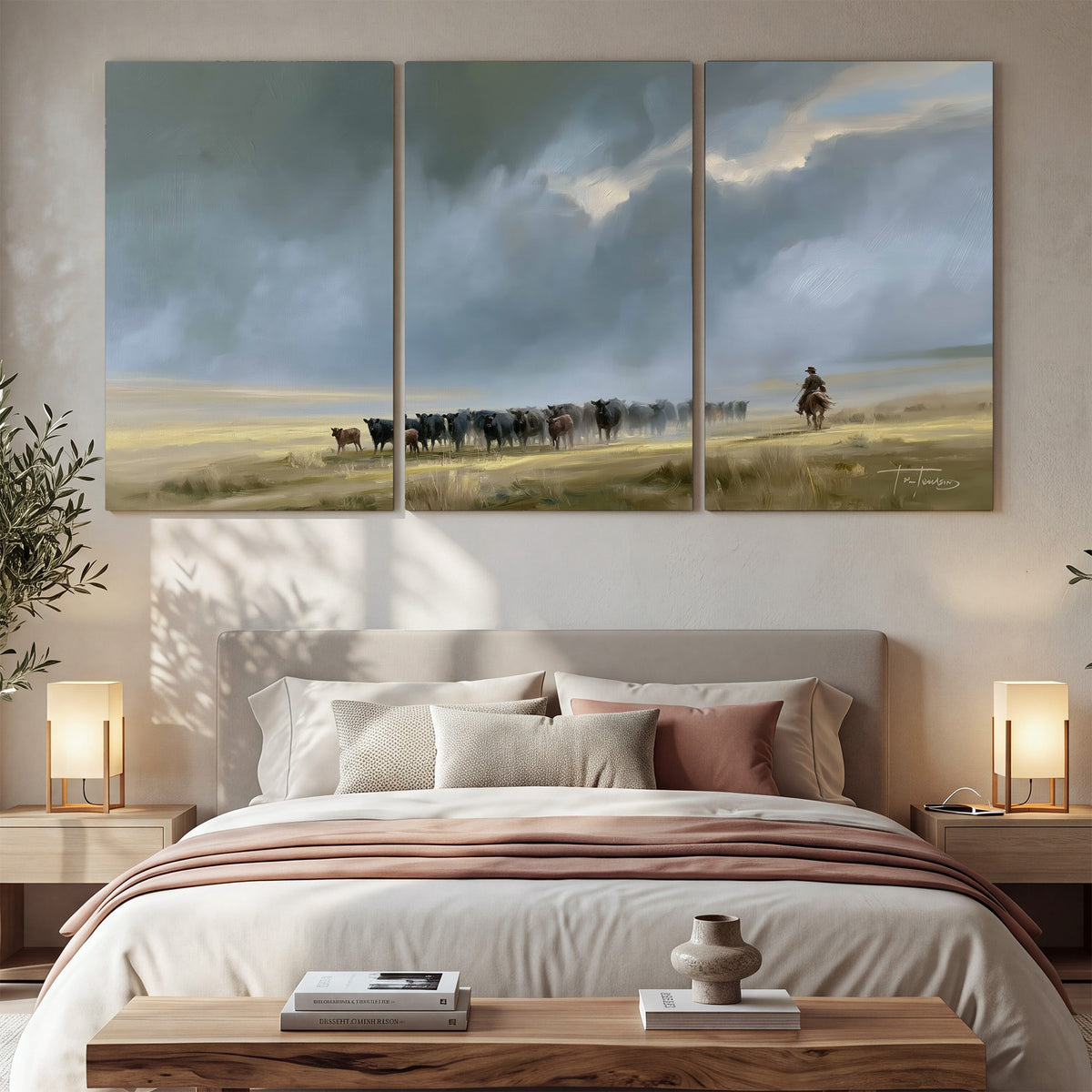 A rider and cattle moving across a sunlit grassland beneath a dramatic blue-gray sky 3 piece canvas wall art displayed in a bedroom