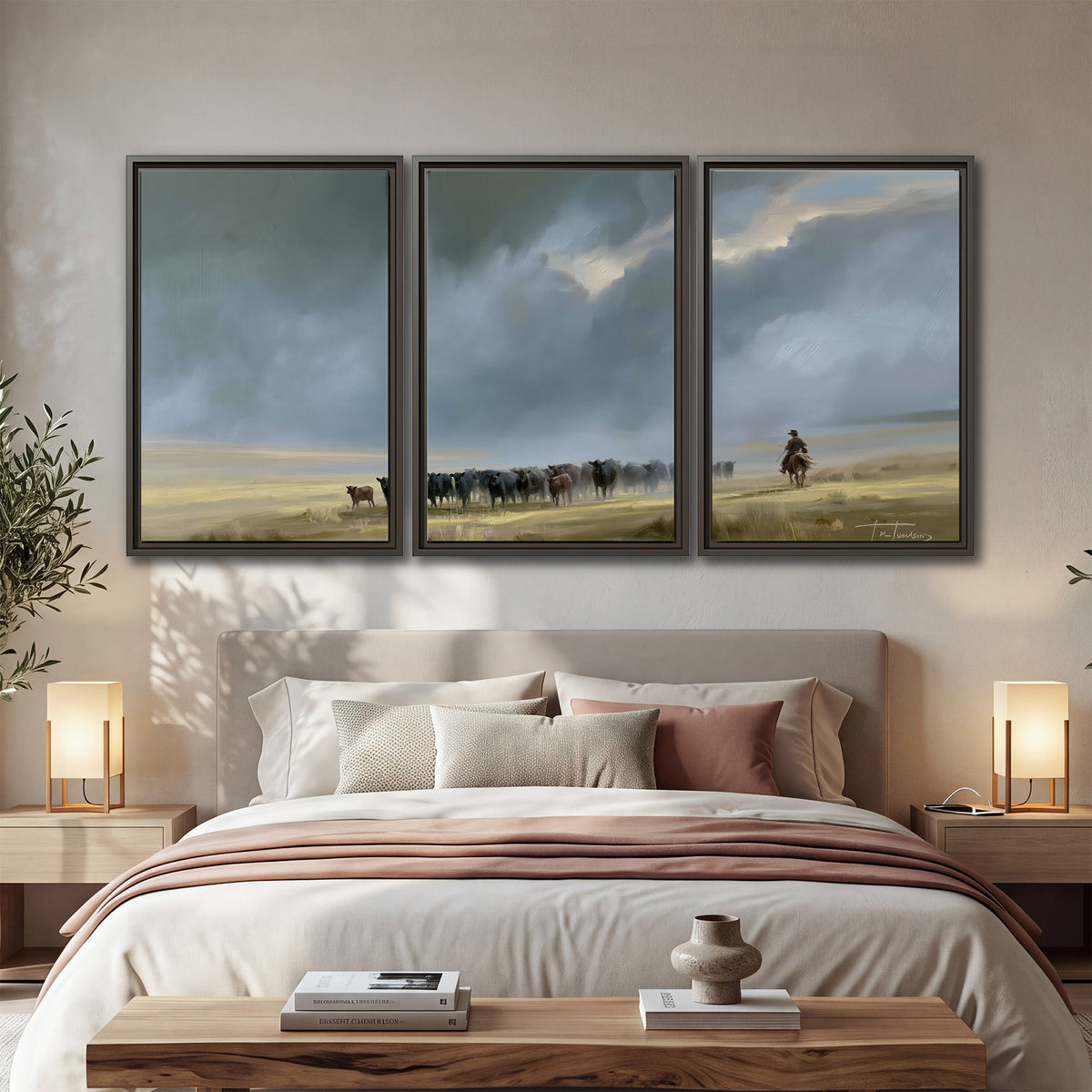 A rider and cattle moving across a sunlit grassland beneath a dramatic blue-gray sky 3 piece framed canvas wall art displayed in a bedroom