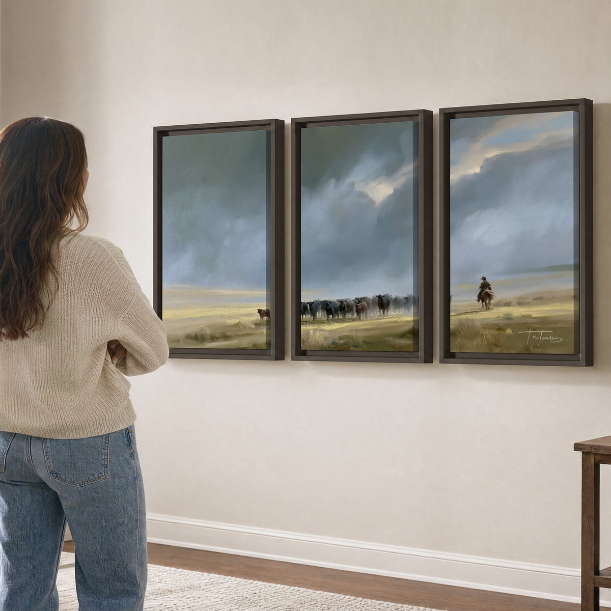 A rider and cattle moving across a sunlit grassland beneath a dramatic blue-gray sky 3 piece framed canvas wall art three panel arrangement on a wall