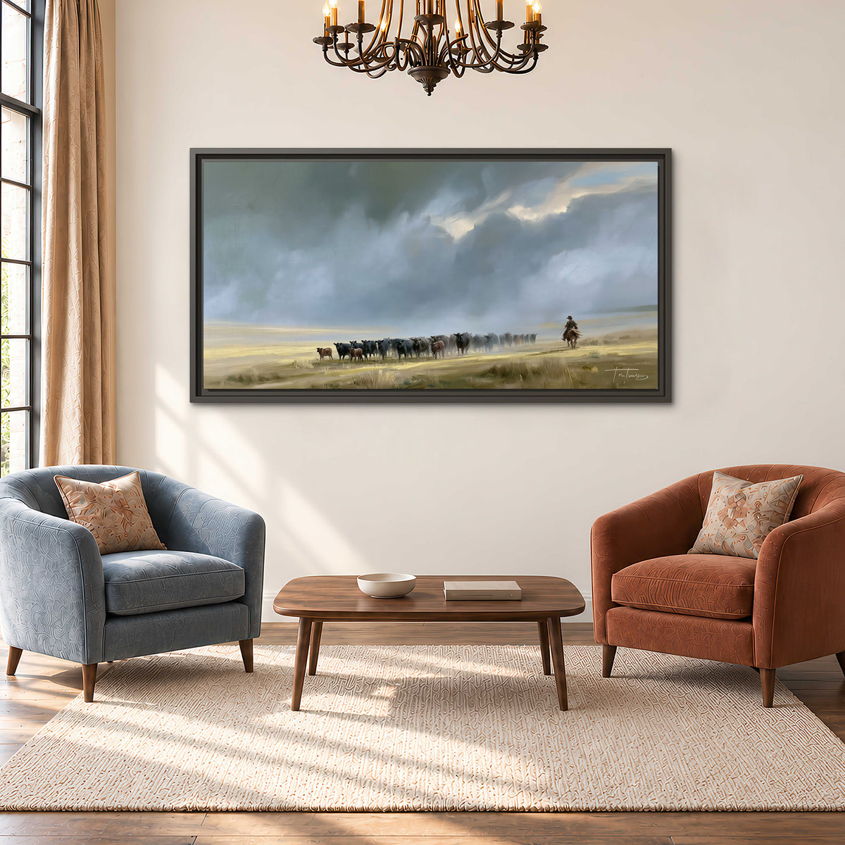 A rider and cattle moving across a sunlit grassland beneath a dramatic blue-gray sky single framed canvas wall art styled in an interior