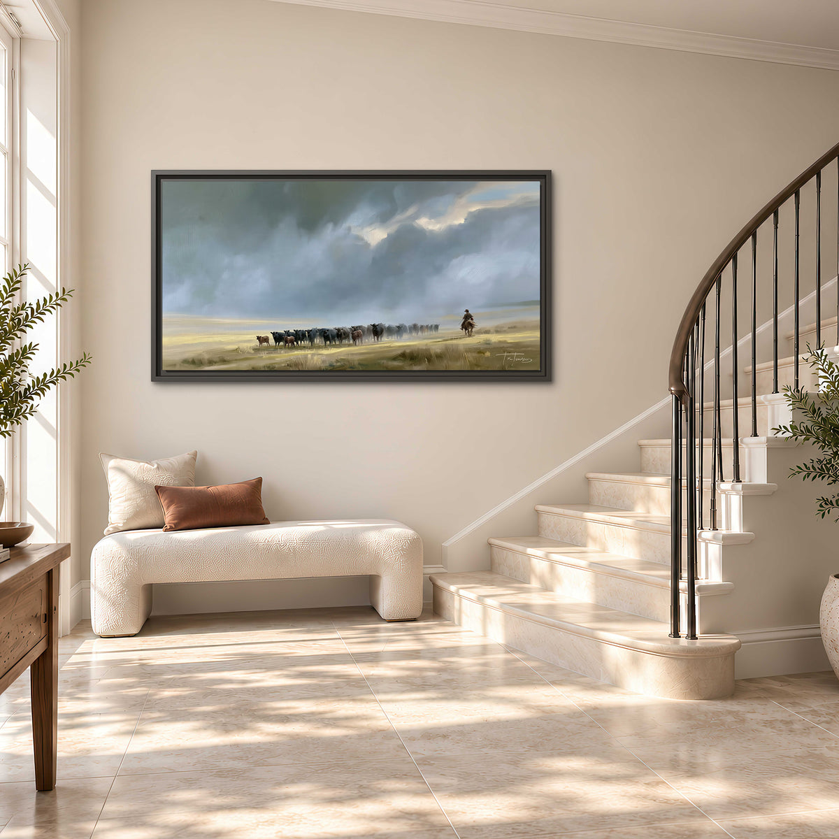 A rider and cattle moving across a sunlit grassland beneath a dramatic blue-gray sky single framed canvas wall art styled in an interior