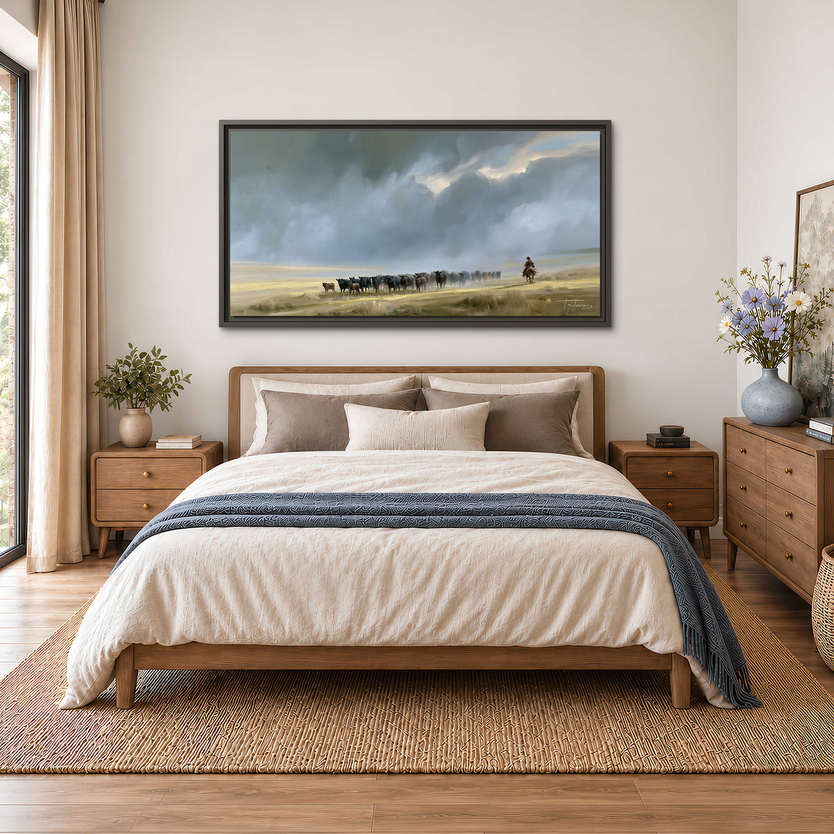 A rider and cattle moving across a sunlit grassland beneath a dramatic blue-gray sky single framed canvas wall art styled in an interior