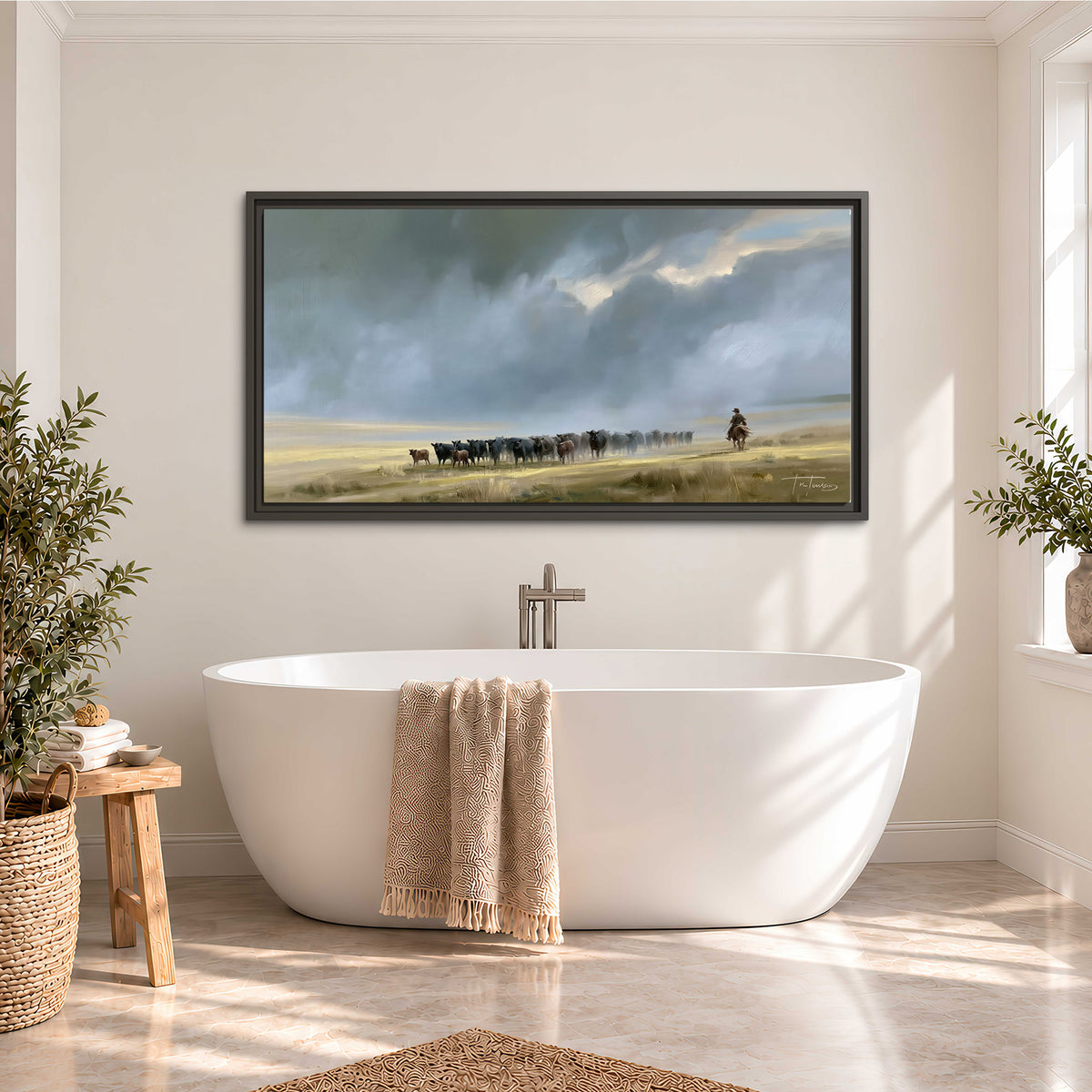 A rider and cattle moving across a sunlit grassland beneath a dramatic blue-gray sky single framed canvas wall art styled in an interior